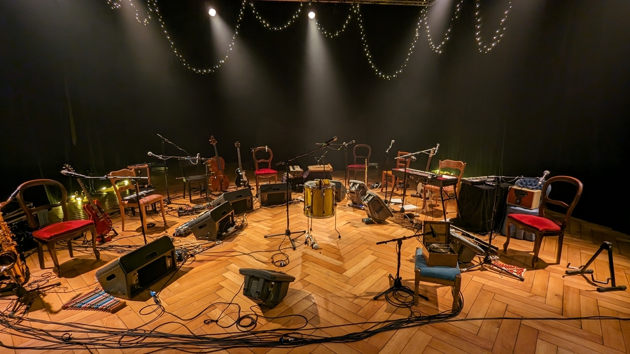 Tout le matériel des huit musicienne·x·s disposé en arc de cercle sur scène.